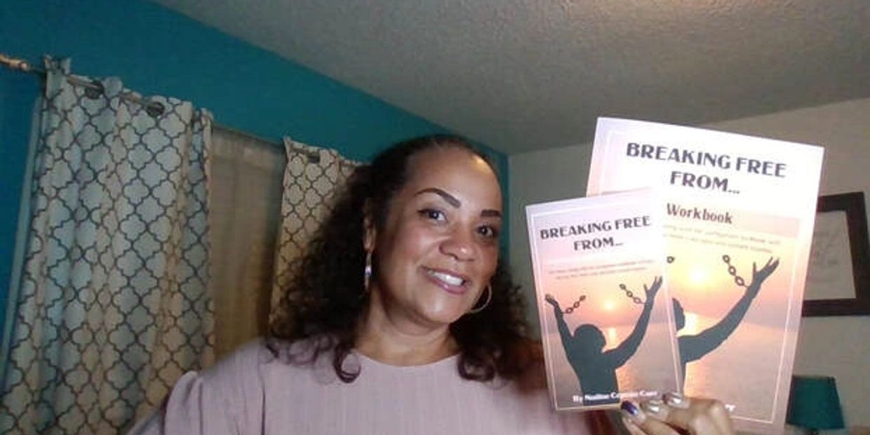 Woman smiling and holding two "Breaking Free From" workbooks.