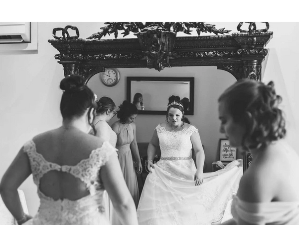 bride in front of antique mirror on wedding day at wedding venue