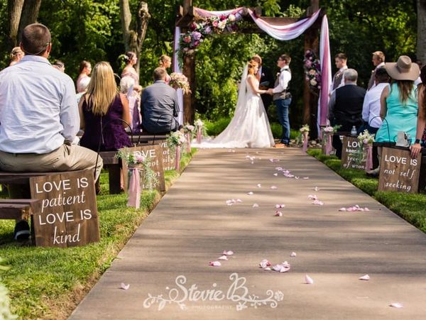bride and groom holding hands at outdoor ceremony area on wedding day