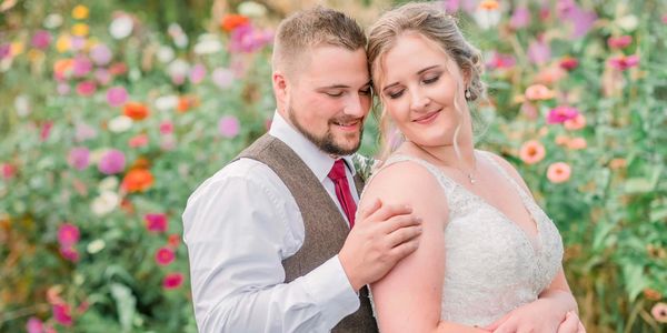 bride and grrom standing in meadow on wedding day
