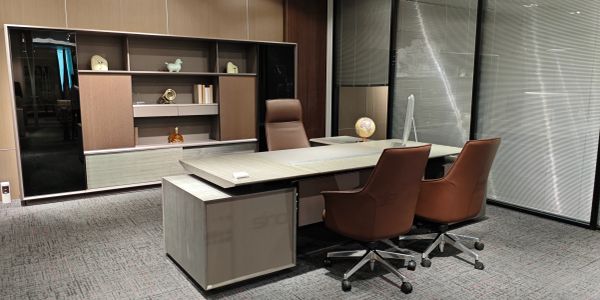 Modern office setup with desk and chairs.