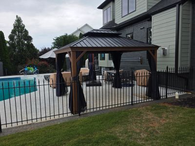 Backyard pool area with gazebo and covered furniture in Greenville assembled by Box to Built.