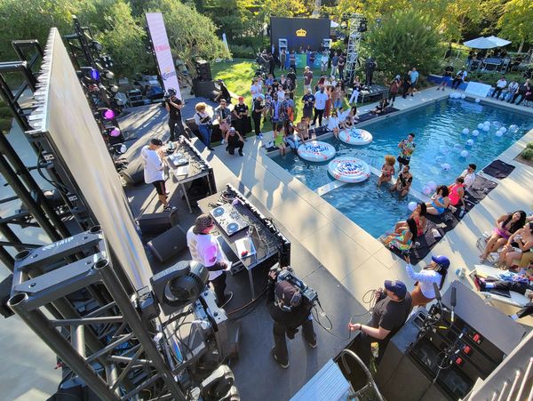 Private concert party with LED walls, facades, and scenic elements surrounding a luxury pool.