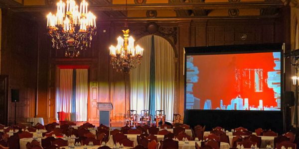 Elegant dinning room symposium with a stage and screen.