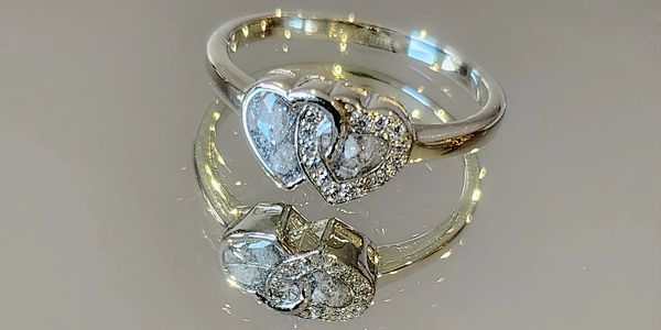 Elegant entwined heart ring, encapsulated ashes of a dearly missed relative.