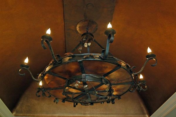 "Exquisite hand-forged chandelier: bespoke design, artisanal craftsmanship, timeless elegance. Eleva