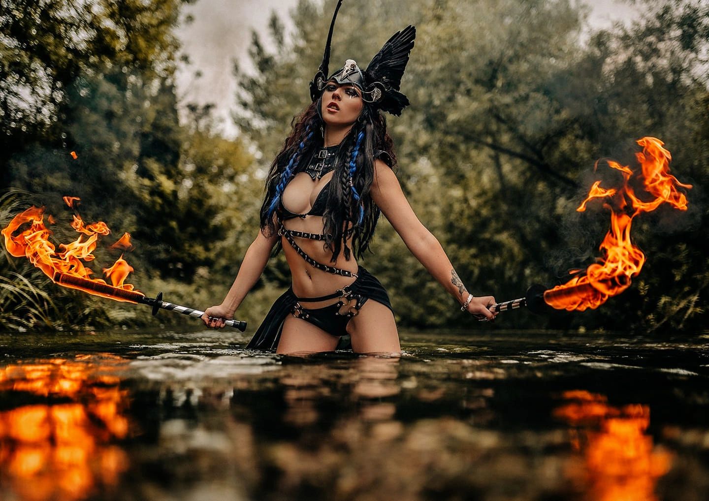 Chloe Elizabxth as a shield maiden with fire swords in a river  