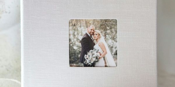 Elegant wedding album with a photo of a bride and groom on the cover.