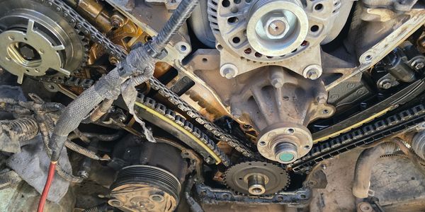 Close-up of an engine's timing chain and components during repair.
