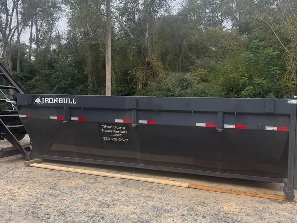 Roll-off dumpster rental in Tifton GA sitting on the ground for easy loading