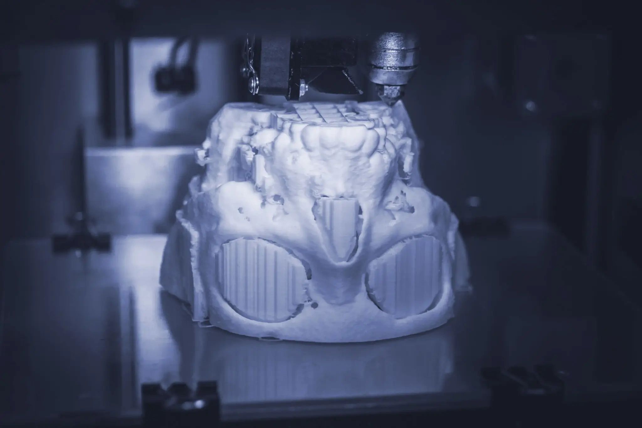 3D printer creating a mechanical part with clean detail and supports