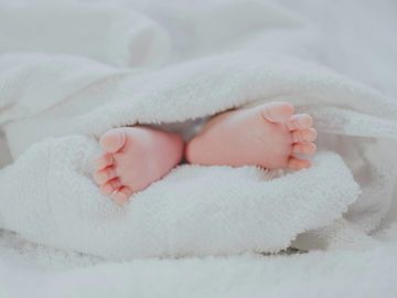 newborn baby's feet in a towel