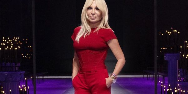 A woman in red is posing for the camera.