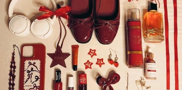 A table with red accessories and shoes on it