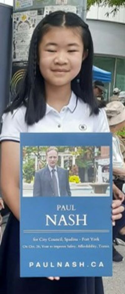 Chinese girl holding a campaign sign for Paul Nash, Candidate for Toronto City Council, Ward 10, Spa