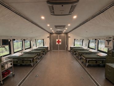 Interior of a U.S. Army mobile medical unit with patient beds and medical equipment.