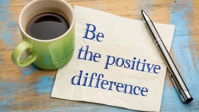 A motivational note with coffee and pen.