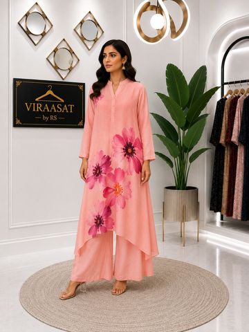 Woman in a pink floral kurta and palazzo set.