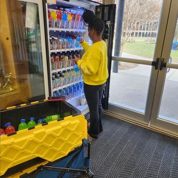 Team member stocking our drink machine