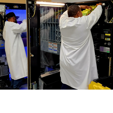 Owners fill up a snack and a drink machine.