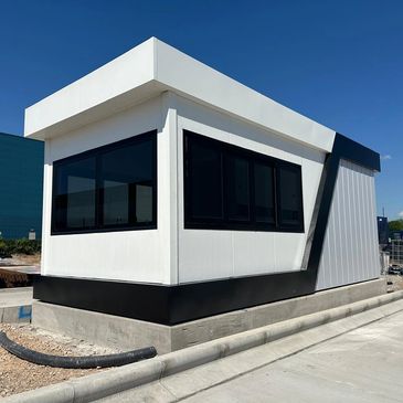 A large bespoke modular gatehouse for trucks at a warehouse.