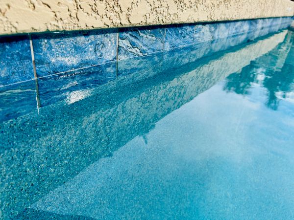 Remodeled Mesa pool with a new Baja shelf, Universal micro-pebble finish, blue waterline tile and Li