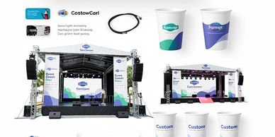Event stage setup with branded screens and cups.
