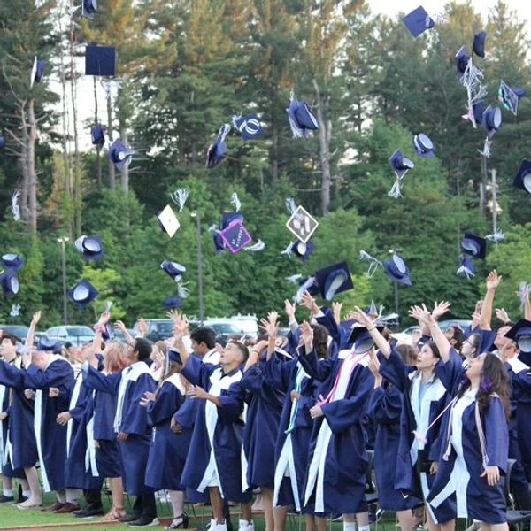 Graduates throw their caps in the air celebrating.