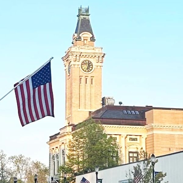 Historic clock tower and American flag.