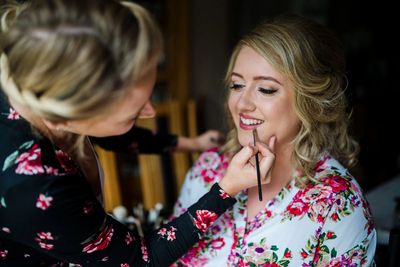 Belfast Makeup Artist applying pink lipstick to bride