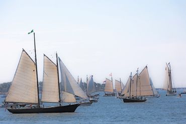 Multiple yachts with people on the water