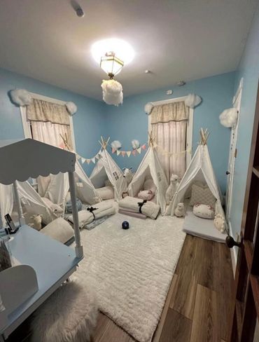 Cozy kids' playroom with mini tents, plush toys, and soft decor.
