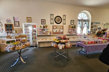 Interior of a quaint candy and snack shop with vintage decor and various treats on display.