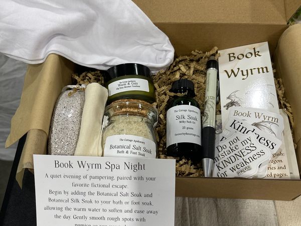 Spa night kit with bath soaks, oils, and kindness-themed bookmarks.