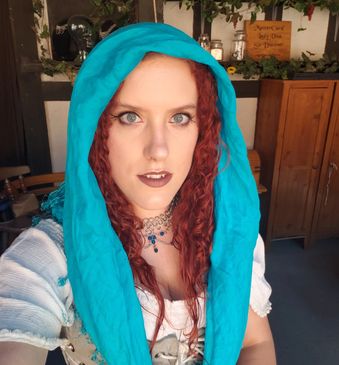 woman wearing chainmaille necklace working in the renaissance festival booth