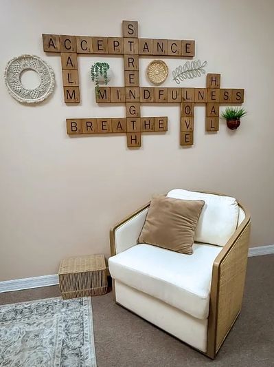 Cozy chair with motivational word wall art.