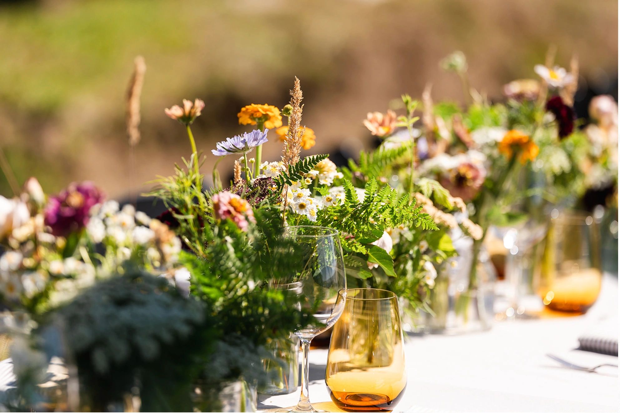Wine country bohemian wedding wildflowers. Rustic table, amber glassware. lorenhansenphotography.com