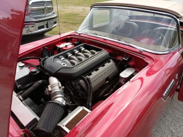 Classic red car with a modern Mustang 5.0 engine swap.