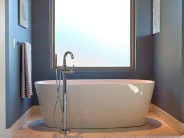 Free standing soaking tub with chrome faucet