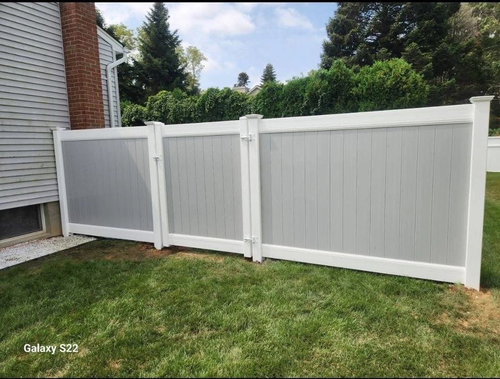 Grey and white two-tone PVC privacy fence.