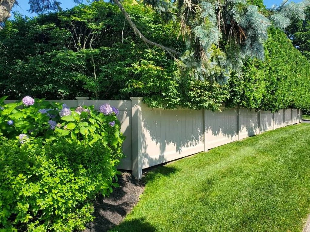 4’ tall white PVC fence against heavy foliage.
