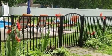 Aluminum pool fence with arched accent gate.