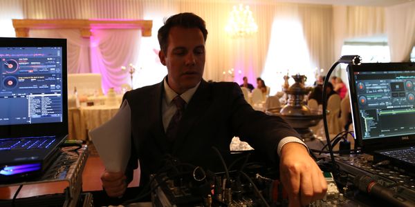 Mobile DJ in front of console at a wedding