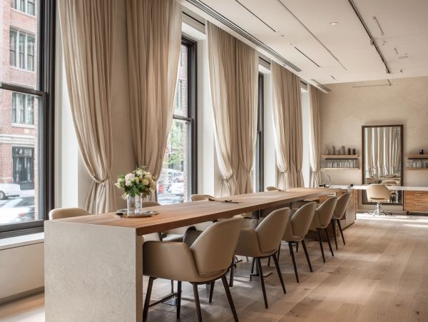 Elegant meeting room with large windows and beige curtains.