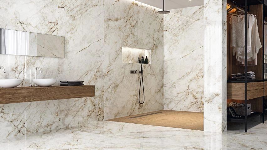 Luxury bathroom with marble walls and wooden accents.
