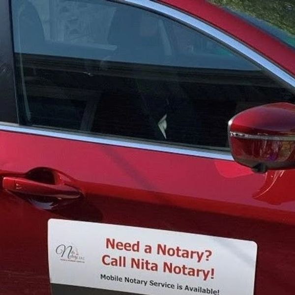 Red Car door with a sign that says, "Need a Notary?" Call Nita Notary! Mobile Notary Service is avai