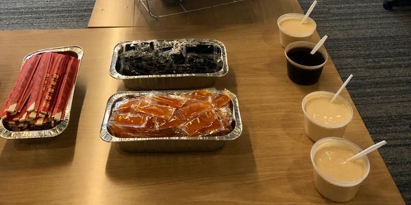 Assorted snacks and drinks arranged on a wooden table.