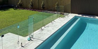Modern garden design with pool, glass fencing and lawn in a Sydney backyard