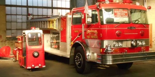 Large red firetruck and small fire engine toy.