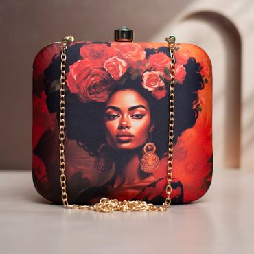A stylish clutch purse with a portrait of a woman adorned with roses and gold earrings.